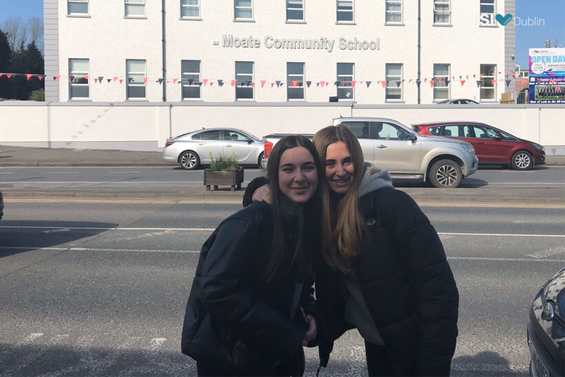 Alba and Sofia in front of their school