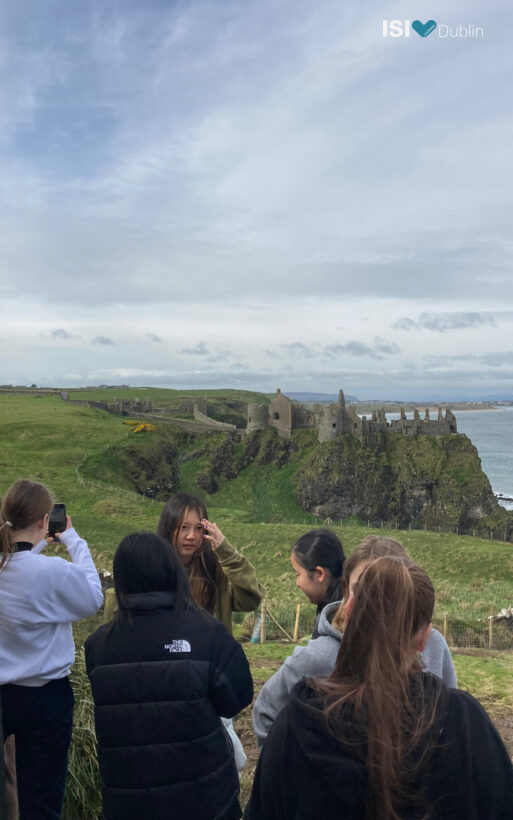 Students having a break to take pics of Dunluce's castle